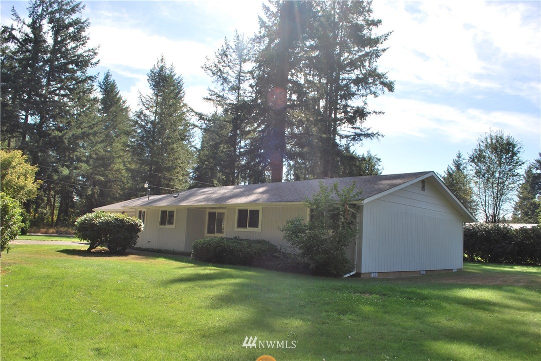5205 185th Avenue Southwest Rochester, WA 98579 - Photo 1 of 17 a view of a house with backyard and garden
