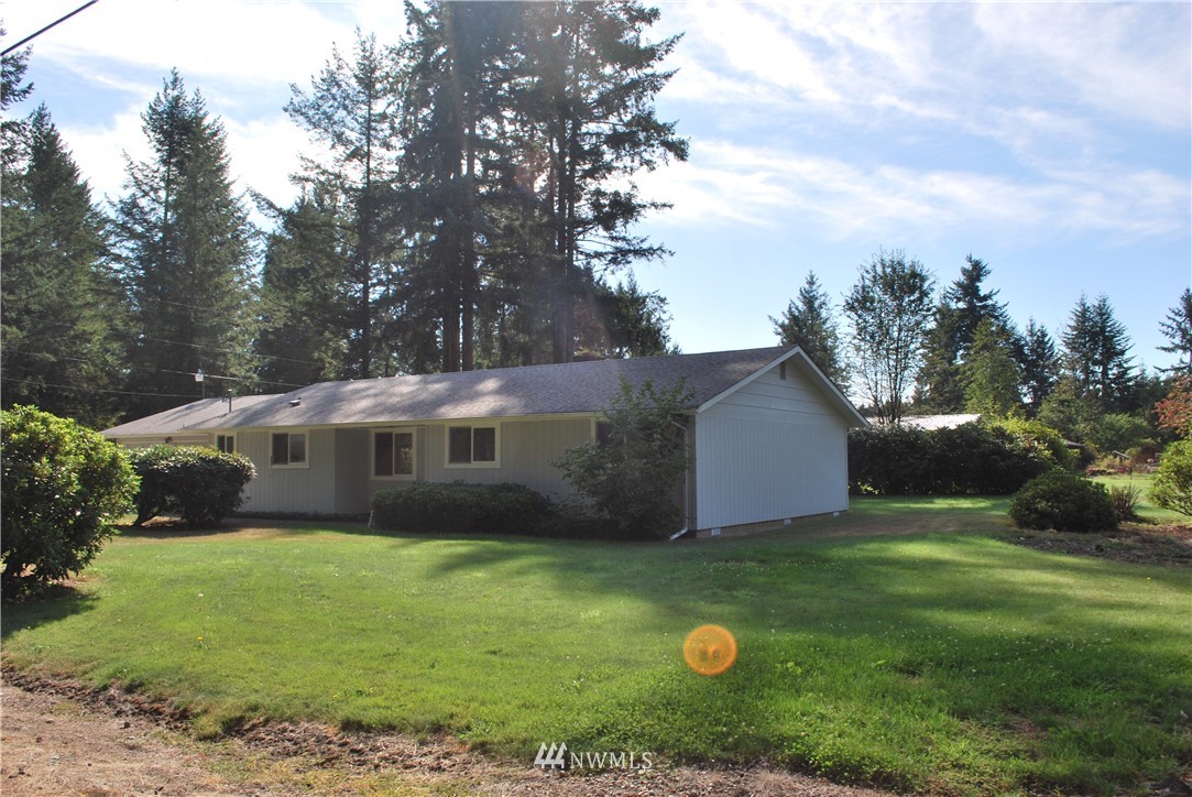 5205 185th Avenue Southwest Rochester, WA 98579 - Photo 12 of 17 a view of a house with a yard and tree