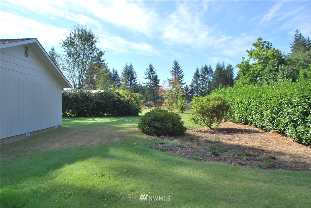 5205 185th Avenue Southwest Rochester, WA 98579 - Photo 14 of 17 a view of a yard with plants and a bench