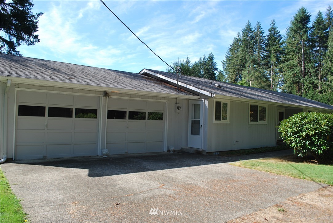 5205 185th Avenue Southwest Rochester, WA 98579 - Photo 3 of 17 a front view of a house with a garden
