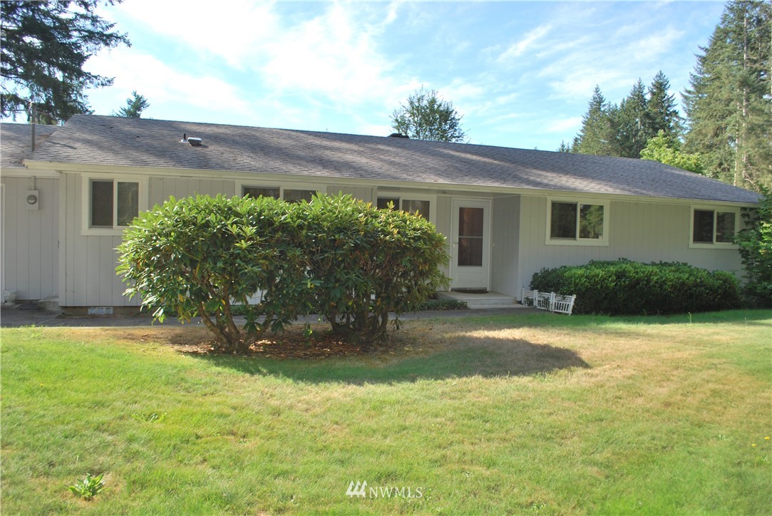 5205 185th Avenue Southwest Rochester, WA 98579 - Photo 4 of 17 a view of a house with a garden