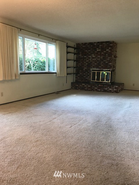 5205 185th Avenue Southwest Rochester, WA 98579 - Photo 6 of 17 an empty room with a fireplace