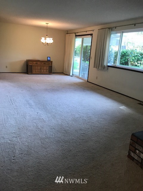 5205 185th Avenue Southwest Rochester, WA 98579 - Photo 7 of 17 an empty room with windows