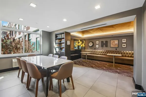 a living room with furniture a wooden floor and next to a window