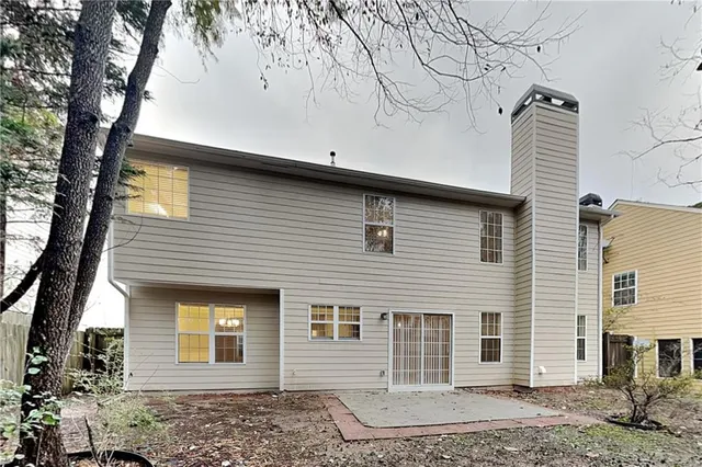a front view of a house with plants