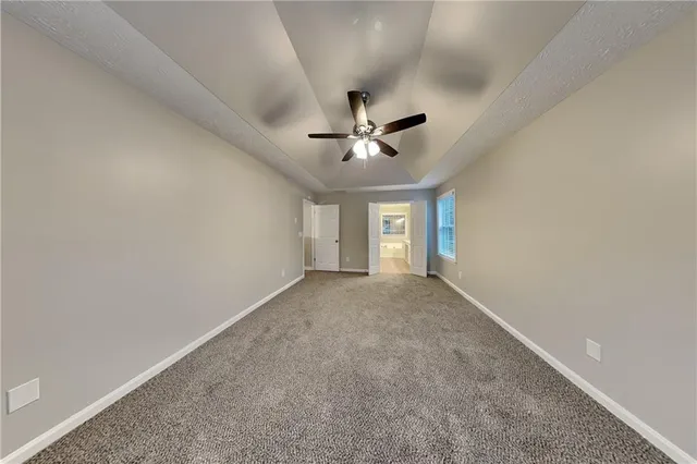 a view of a livingroom with a ceiling fan and window