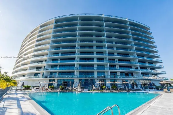 a view of a tall building with a yard