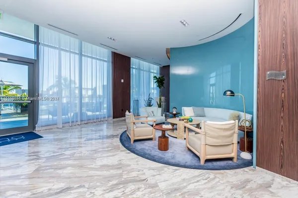 a living room with furniture a large window and wooden floor