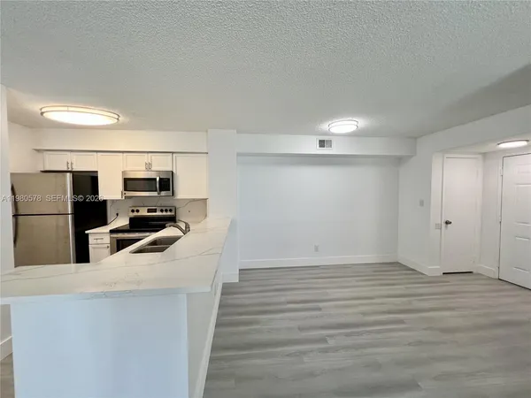 a kitchen with stainless steel appliances a refrigerator and a stove