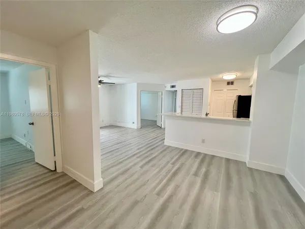 a view of a room with wooden floor and window