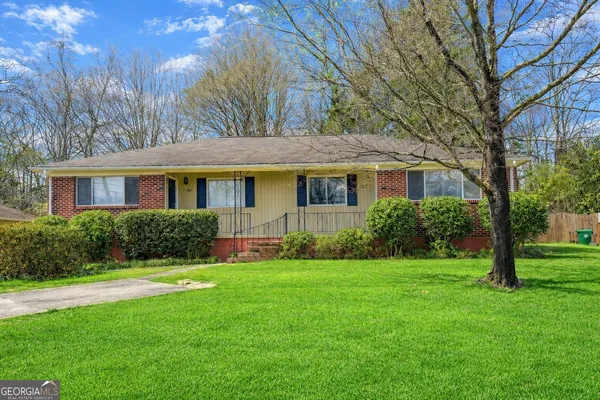 a front view of house with yard and green space
