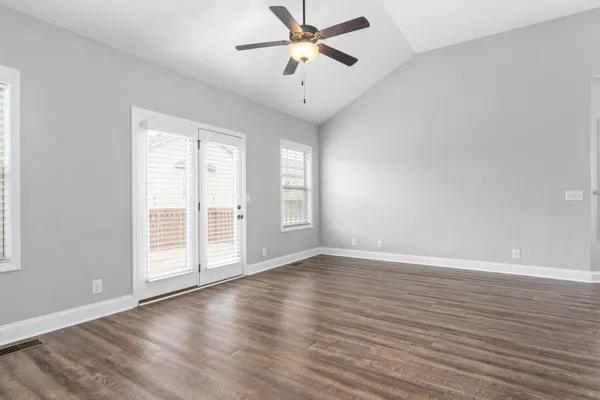 wooden floor in an empty room with a window
