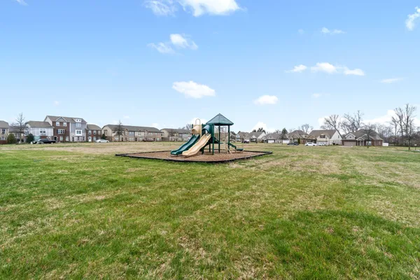 a view of a house with a yard and plants