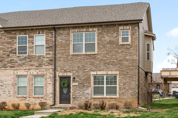 a front view of a house with a yard
