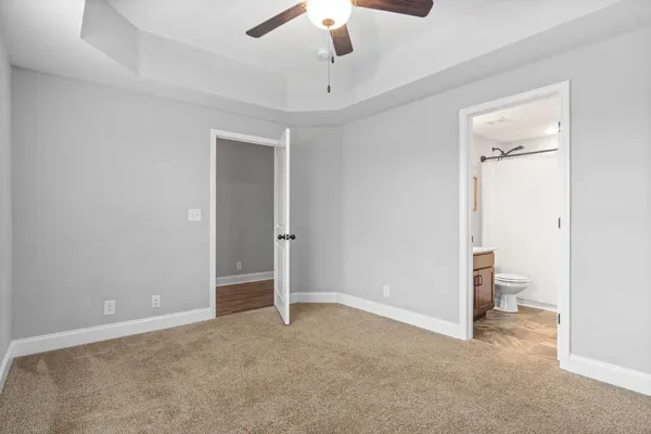 a view of an empty room and a bathroom