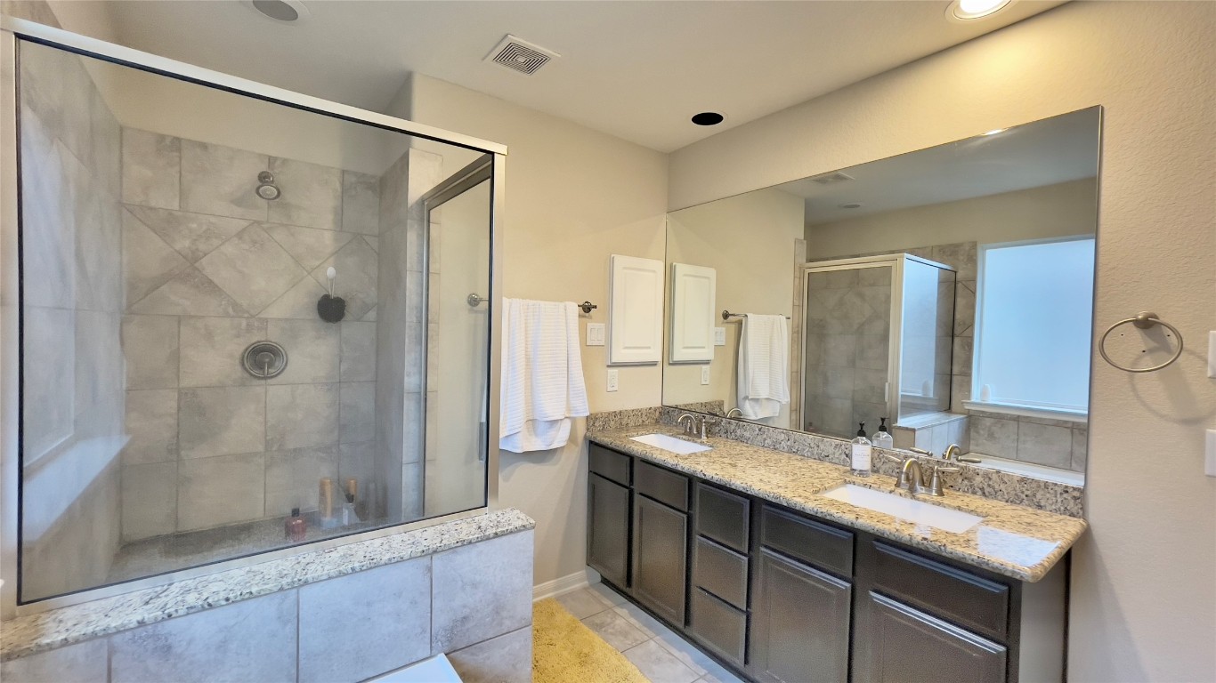 21618 Ivory Gate Lane Katy, TX 77449 - Photo 27 of 32 a bathroom with a granite countertop sink mirror and shower