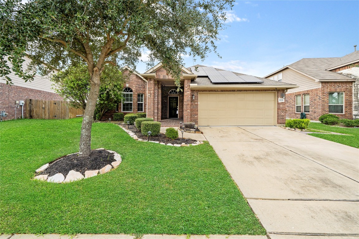 21618 Ivory Gate Lane Katy, TX 77449 - Photo 3 of 32 a front view of a house with a yard and garage
