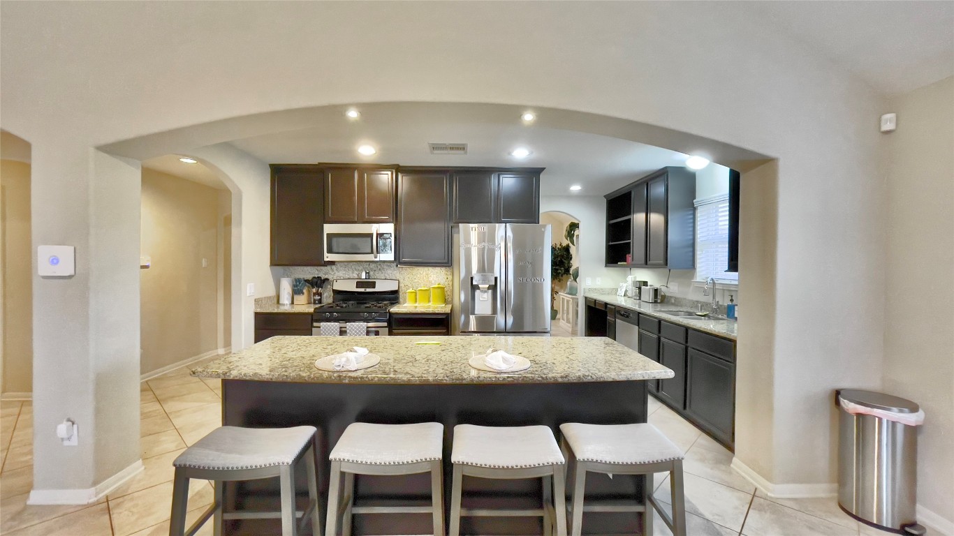 21618 Ivory Gate Lane Katy, TX 77449 - Photo 8 of 32 a kitchen with a dining table chairs and refrigerator