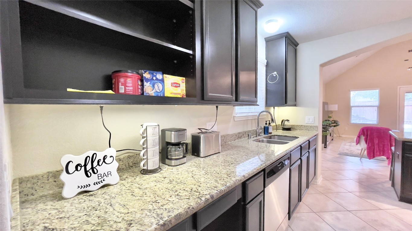 21618 Ivory Gate Lane Katy, TX 77449 - Photo 9 of 32 a kitchen with a granite countertop sink and a stove