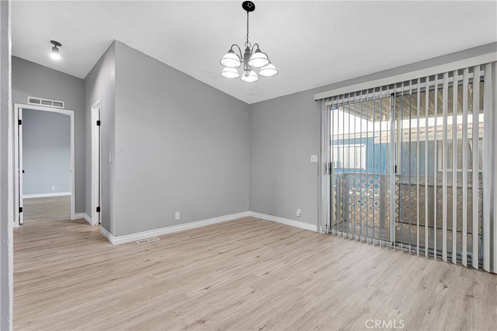 8450 G Avenue, Unit 63 Hesperia, CA 92345 - Photo 11 of 31 wooden floor in an empty room with a window
