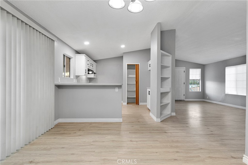 8450 G Avenue, Unit 63 Hesperia, CA 92345 - Photo 12 of 31 a view of a kitchen with wooden floor and a window