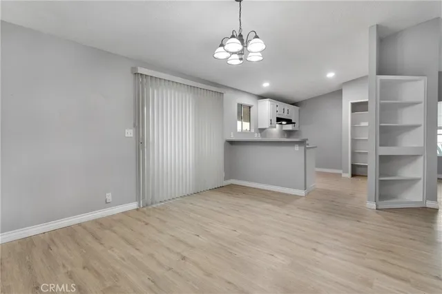 a view of a kitchen with a sink and dishwasher a refrigerator with wooden floor