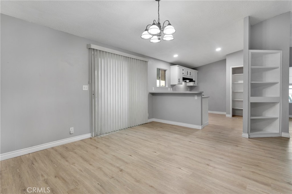 8450 G Avenue, Unit 63 Hesperia, CA 92345 - Photo 13 of 31 a view of a kitchen with a sink and dishwasher a refrigerator with wooden floor