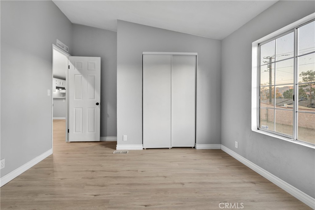8450 G Avenue, Unit 63 Hesperia, CA 92345 - Photo 28 of 31 a view of an empty room with wooden floor and a window