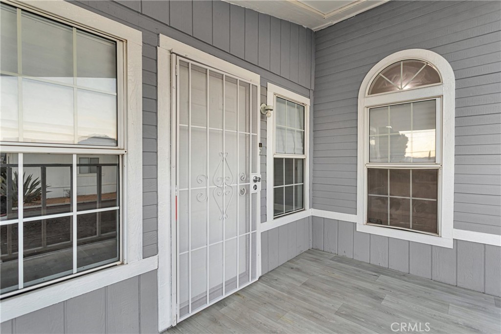 8450 G Avenue, Unit 63 Hesperia, CA 92345 - Photo 7 of 31 an empty room with wooden floor and windows