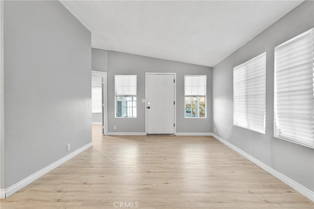 8450 G Avenue, Unit 63 Hesperia, CA 92345 - Photo 8 of 31 an empty room with wooden floor and windows