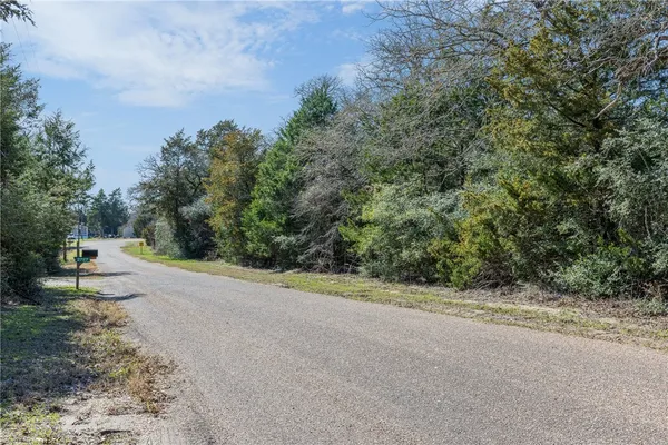 a view of a road with a yard