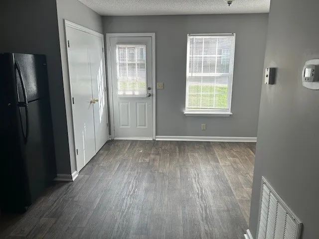 a view of a room with wooden floor and a window