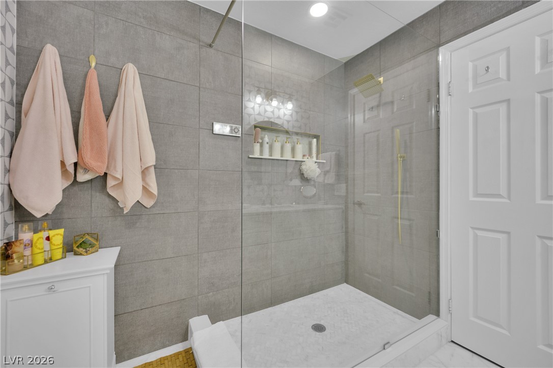 530 Grape Drive Henderson, NV 89015 - Photo 20 of 39 A sleek, contemporary bathroom with a spacious glass-enclosed shower.
