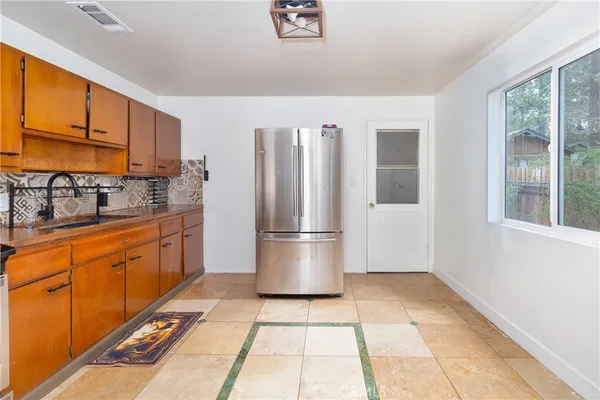 a kitchen with stainless steel appliances a refrigerator sink and cabinets
