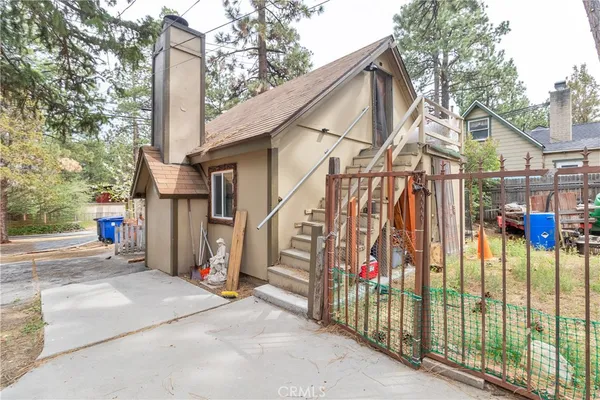 a view of a house with wooden fence