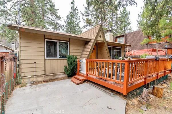 a view of a house with a wooden fence