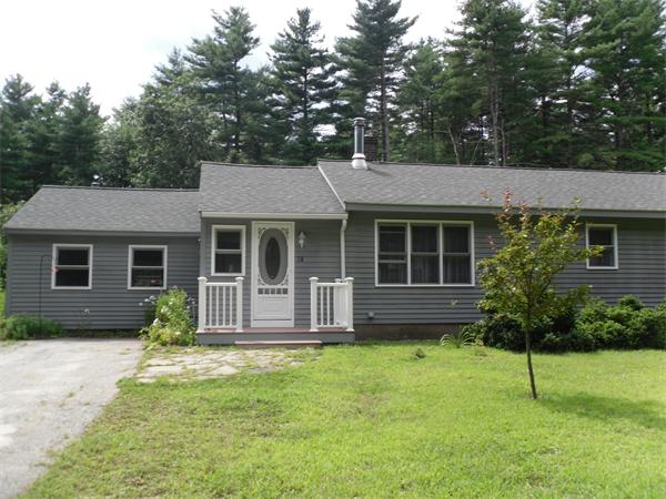 18 Barker Hill Road Townsend, MA 01469 - Photo 1 of 22 a front view of a house with a garden and porch