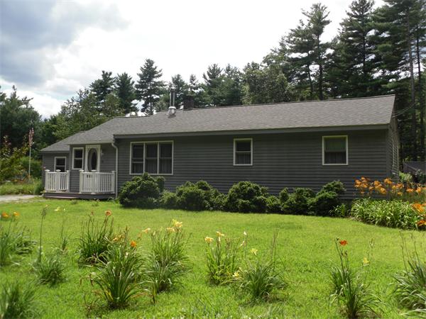 18 Barker Hill Road Townsend, MA 01469 - Photo 3 of 22 a front view of a house with a yard and garage