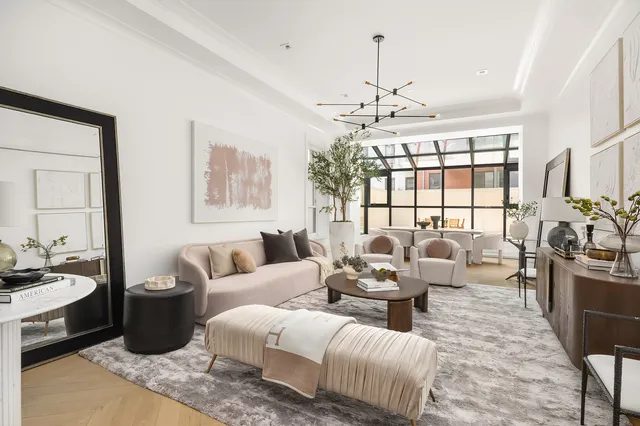 a living room with furniture or chandelier and a wooden floor