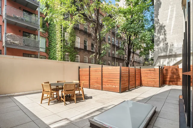 a view of a dining room with furniture large windows and wooden floor