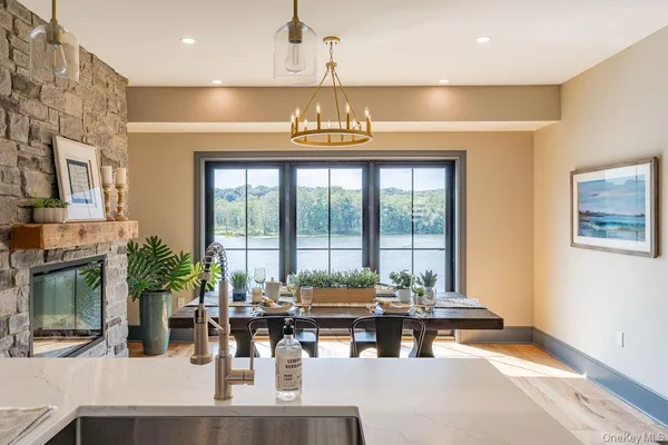 a living room with fireplace furniture and a large window