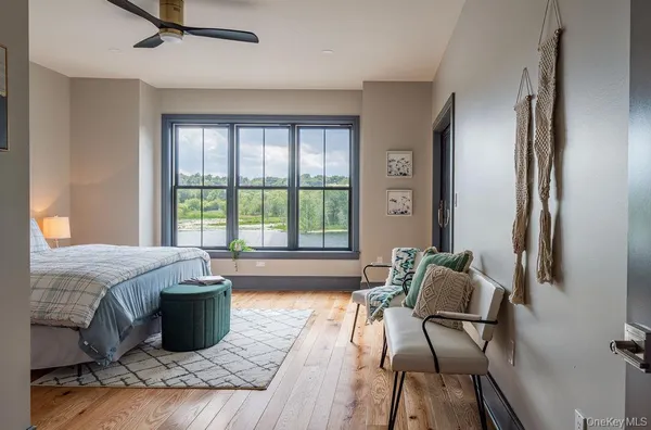 a bed sitting in a bedroom next to a window