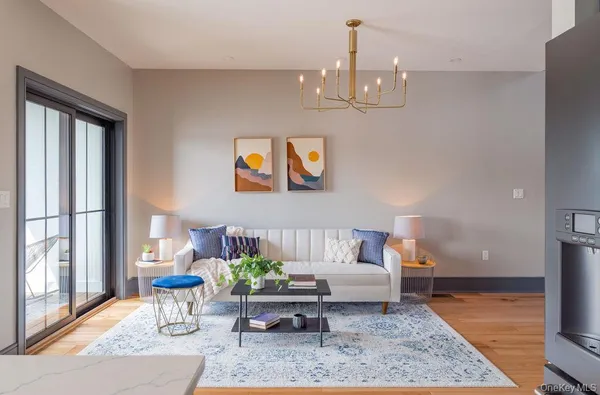 a living room with furniture and a chandelier