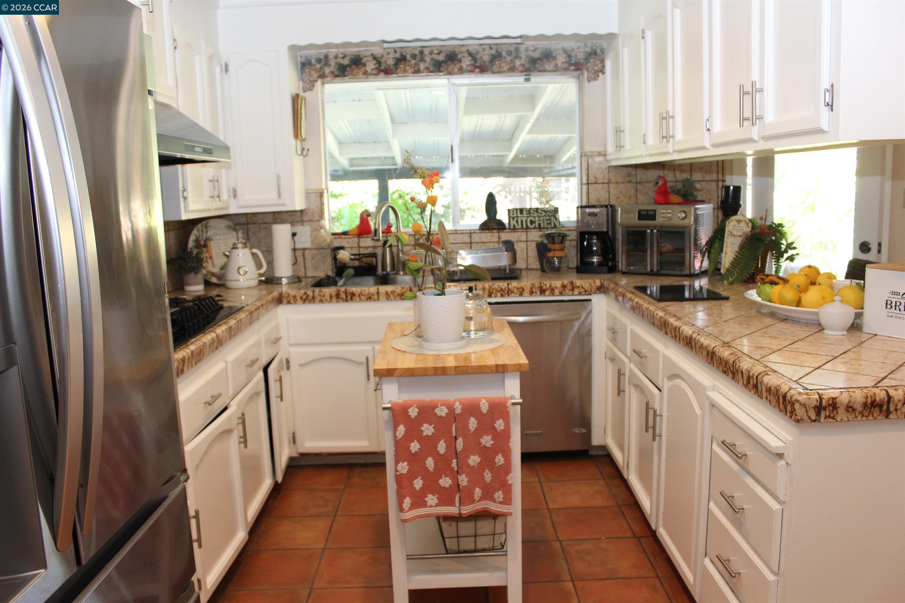 330 West Cypress Road Oakley, CA 94561 - Photo 17 of 59 a kitchen with stainless steel appliances granite countertop a sink and a refrigerator
