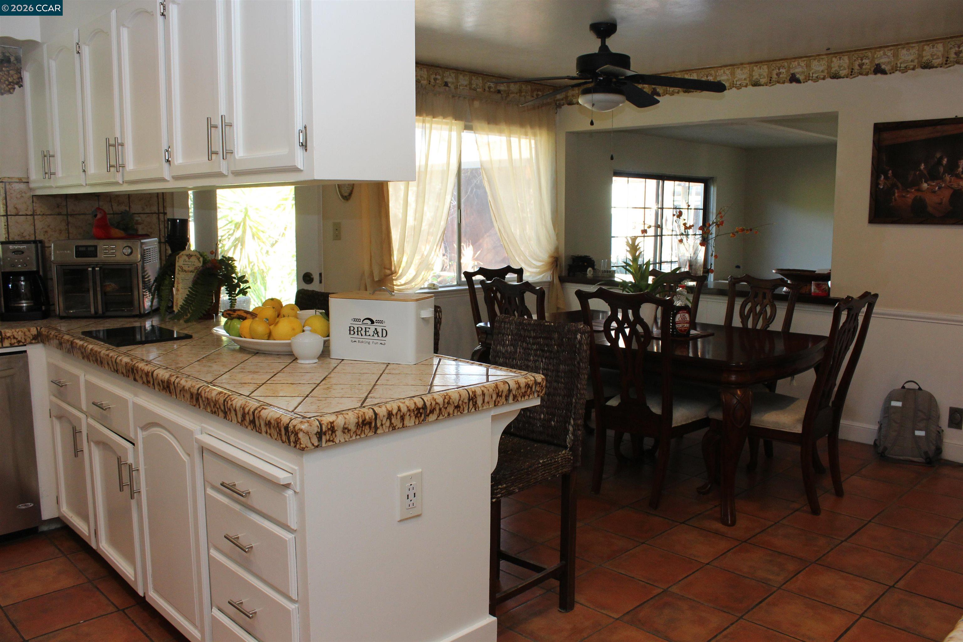 330 West Cypress Road Oakley, CA 94561 - Photo 20 of 59 a kitchen with stainless steel appliances granite countertop a dining table chairs and a refrigerator