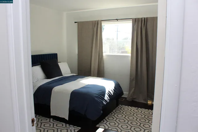 a bedroom with a bed and a window