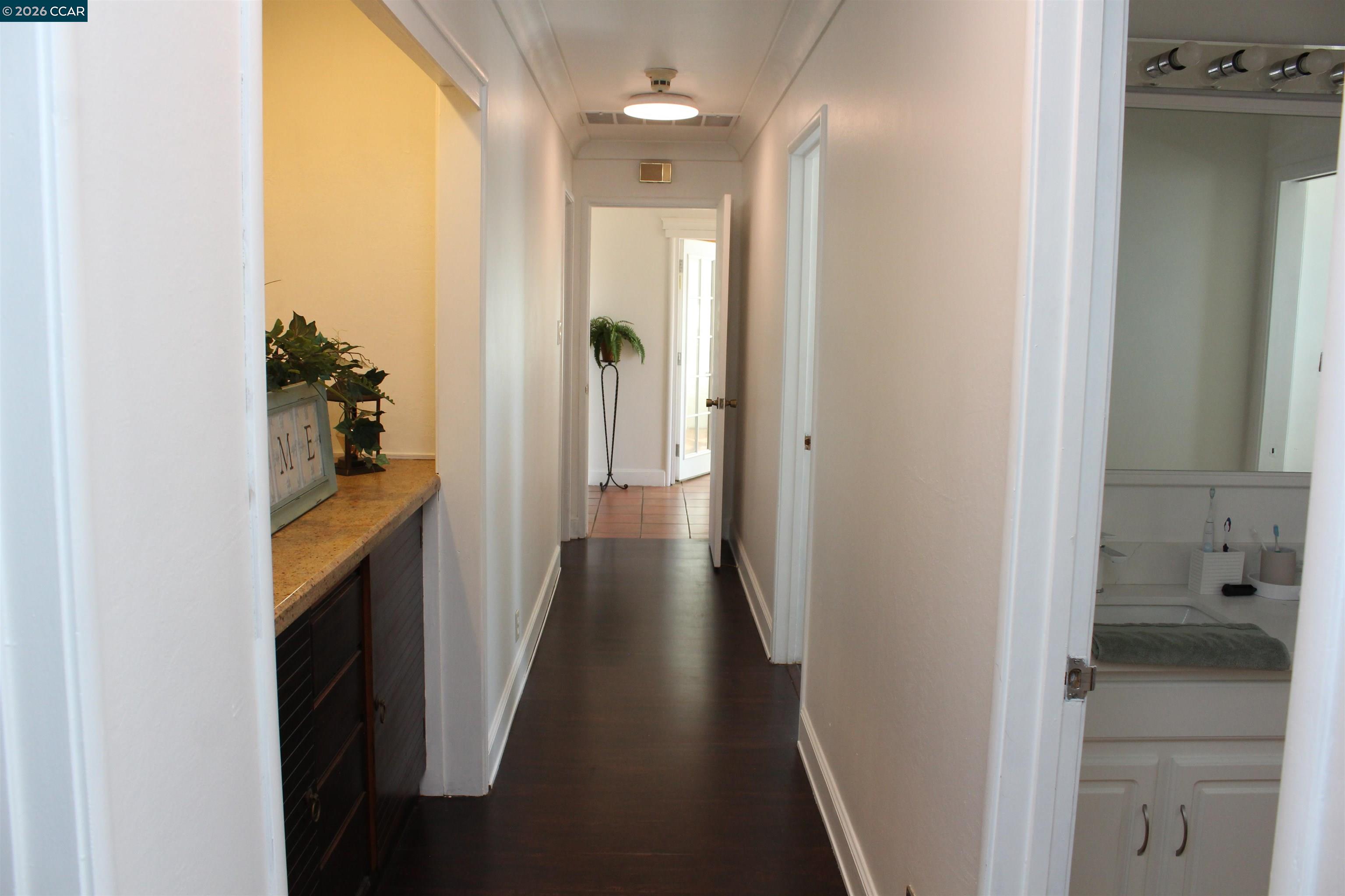 330 West Cypress Road Oakley, CA 94561 - Photo 44 of 59 a view of a hallway with wooden floor and a bathroom