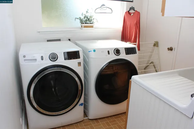 a backyard of a house with garden and outdoor seating