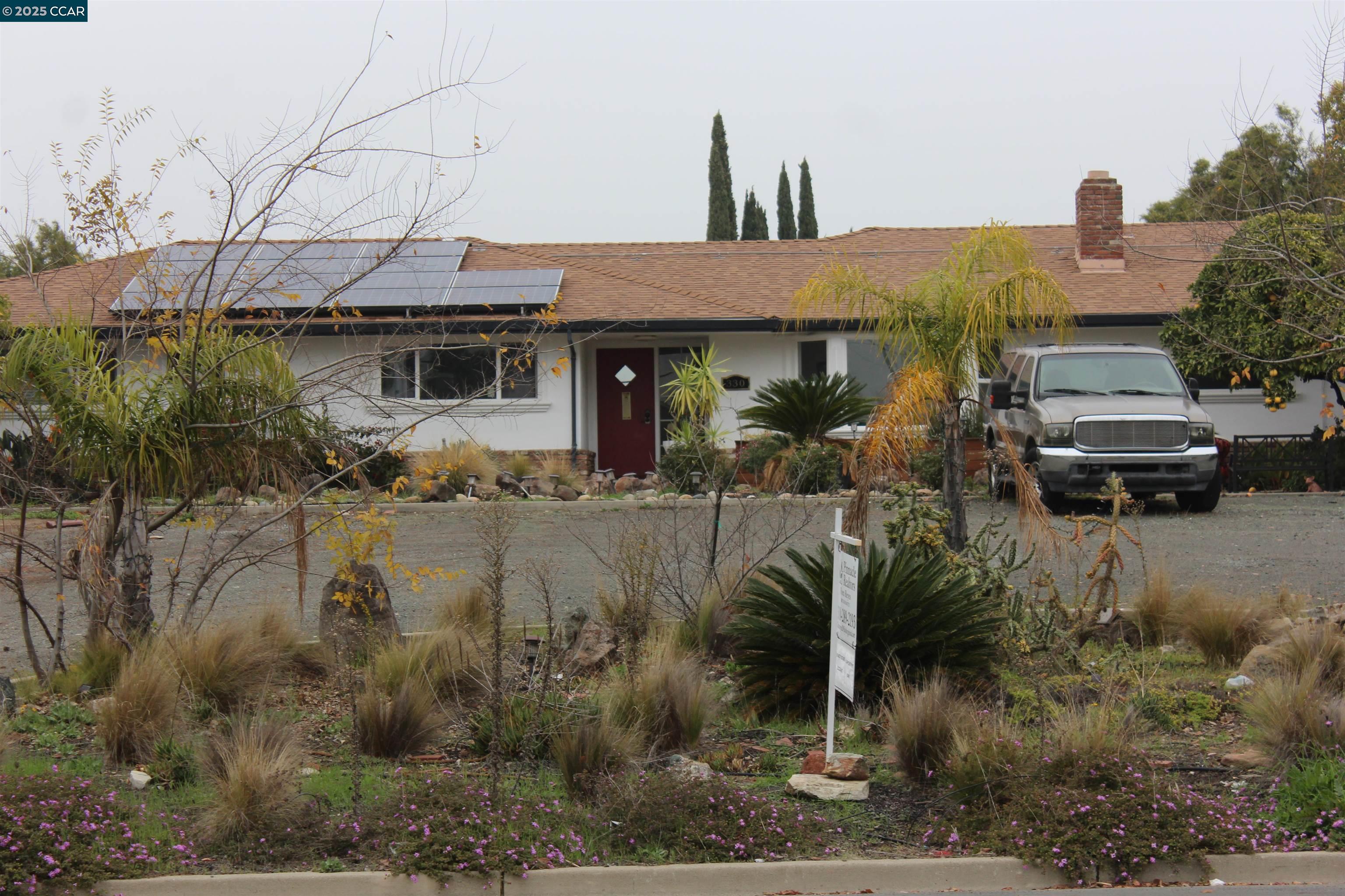 330 West Cypress Road Oakley, CA 94561 - Photo 5 of 12 a front view of a house with a yard