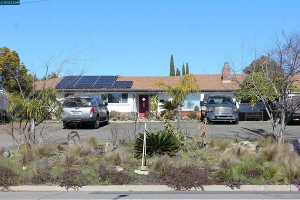 a view of a cars park in front of a building